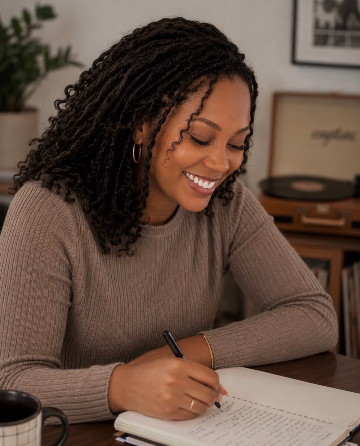 Niara Michael writing in her studio
