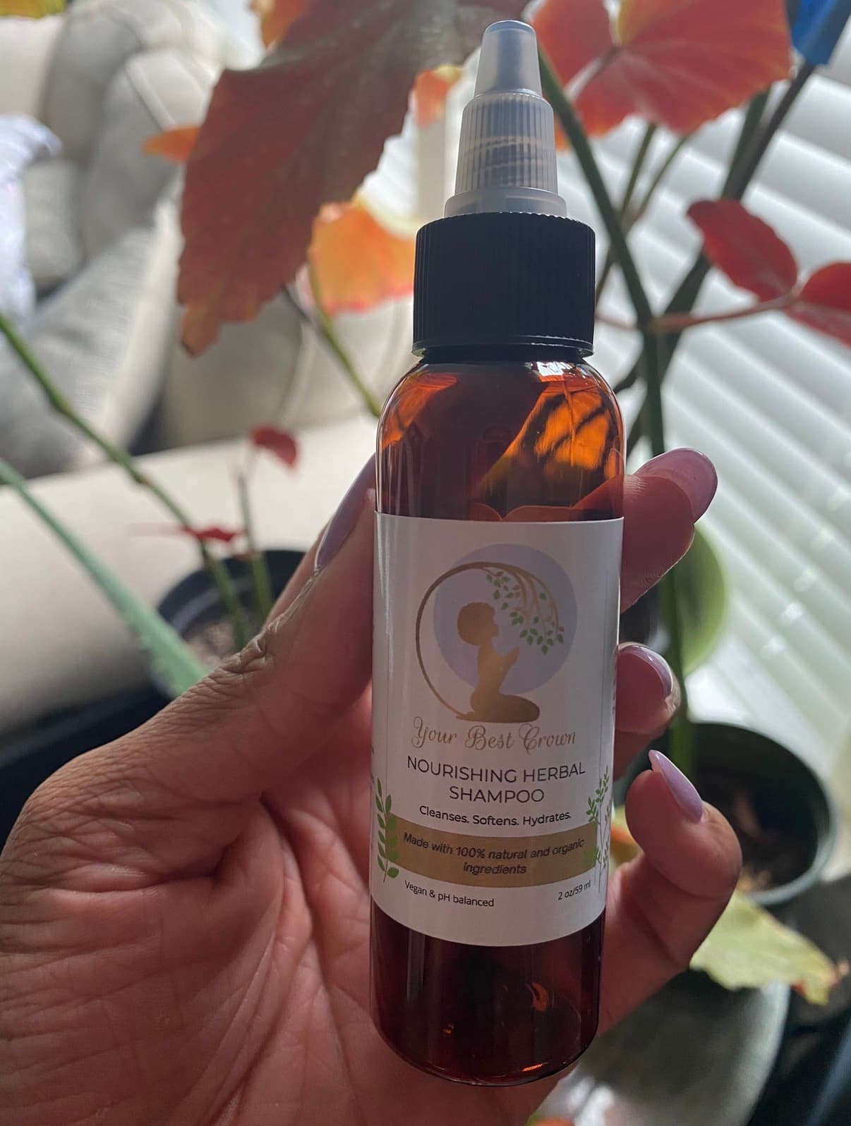 A physical Your Best Crown shampoo bottle held in hand